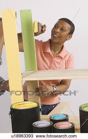 Stock Image - African American Couple Doing Home Improvement Painting, Canada, British Columbia. Fotosearch