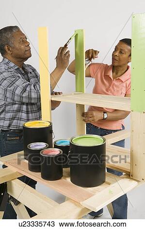 Stock Image - African American Couple Doing Home Improvement Painting, Canada, British Columbia. Fotosearch