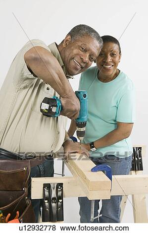 Stock Photo - African American Couple Doing Home Improvement, B. C.. Fotosearch