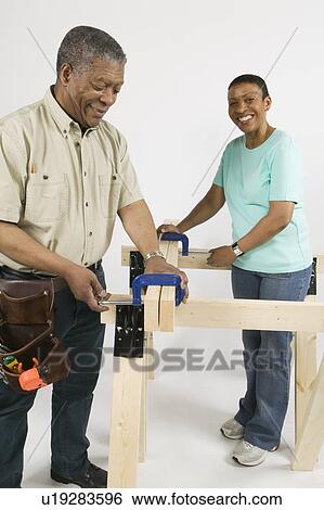 Stock Photograph - African American Couple Doing Home Improvement, Canada, British Columbia. Fotosearch
