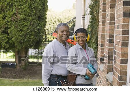 Stock Photography - African American couple doing home improvement, Vancouver, BC. Fotosearch