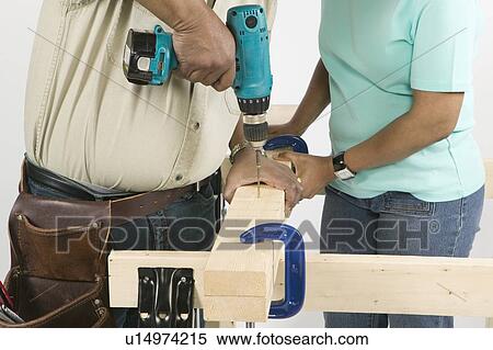 Stock Photography - African American Couple Doing Home Improvement, Canada, British Columbia. Fotosearch