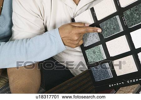 Stock Image - African American couple going over granite samples, Vancouver, BC. Fotosearch