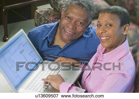 African American couple using a laptop to design a new home or renovation, Vancouver, BC View Large Photo Image Stock Photo - African American couple using a laptop to design a new home or renovation, Vancouver, BC. Fotosearch