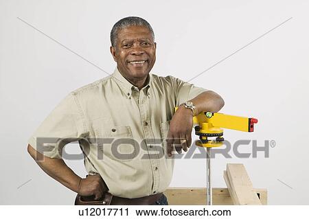 African American Man Doing Home Improvement, Using Laser Level, B. C. View Large Photo Image Stock Image - African American Man Doing Home Improvement, Using Laser Level, B. C.. Fotosearch