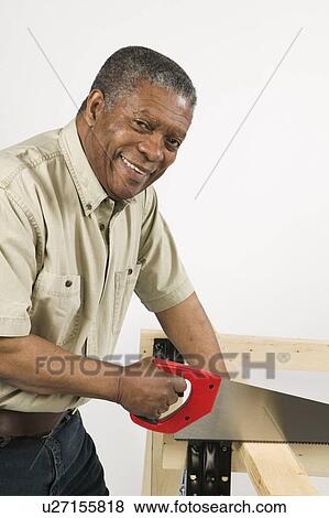 Stock Photo - African American Man Doing Home Improvement, B. C.. Fotosearch