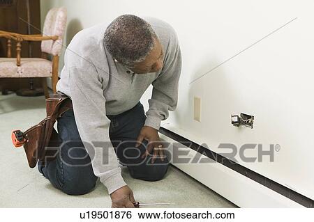 African American man working on a household receptacle, Vancouver, BC View Large Photo Image Stock Photograph - African American man working on a household receptacle, Vancouver, BC. Fotosearch