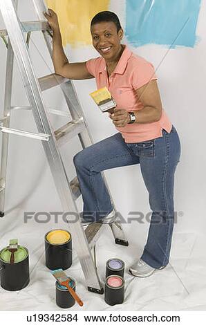 African American Woman Doing Home Improvement Painting, Canada, British Columbia View Large Photo Image Picture - African American Woman Doing Home Improvement Painting, Canada, British Columbia. Fotosearch