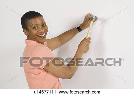 Stock Image - African American Woman Doing Home Improvement, Canada, British Columbia. Fotosearch