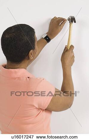 Stock Photo - African American Woman Doing Home Improvement, Canada, British Columbia. Fotosearch
