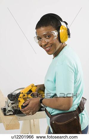 African American Woman Doing Home Improvement, Cutting Lumber With a Skill Saw, Vancouver, BC View Large Photo Image Stock Photograph - African American Woman Doing Home Improvement, Cutting Lumber With a Skill Saw, Vancouver, BC. Fotosearch