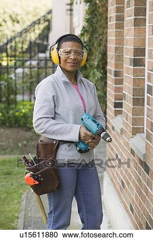 African American woman using a hand drill, Vancouver, BC View Large Photo Image Stock Image - African American woman using a hand drill, Vancouver, BC. Fotosearch