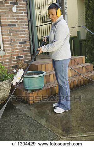 African American woman using a power washer, Vancouver, BC View Large Photo Image Stock Photo - African American woman using a power washer, Vancouver, BC. Fotosearch