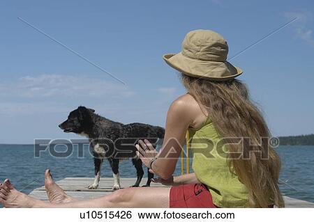 Woman and dog on dock; Canada, Manitoba, Riding Mountain National Park View Large Photo Image Stock Photograph - Woman and dog on dock; Canada, Manitoba, Riding Mountain National Park. Fotosearch