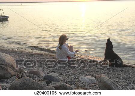 Woman with dog at beach Clear Lake; Canada, Manitoba, Riding Mountain National Park View Large Photo Image Stock Photography - Woman with dog at beach Clear Lake; Canada, Manitoba, Riding Mountain National Park. Fotosearch