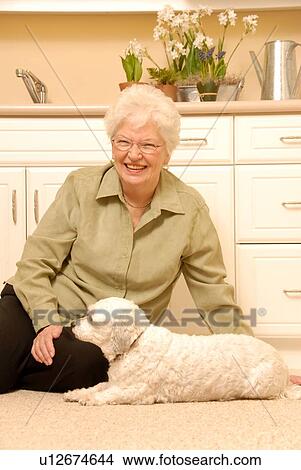 Picture - Senior Woman white dog; Canada, Saskatchewan, Regina. Fotosearch
