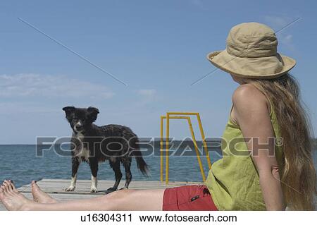 Woman and dog on dock; Canada, Manitoba, Riding Mountain National Park View Large Photo Image Stock Image - Woman and dog on dock; Canada, Manitoba, Riding Mountain National Park. Fotosearch