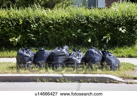 Stock Photo - 6 garbage bags put out for collection, Toronto, Ontario, Canada. Fotosearch