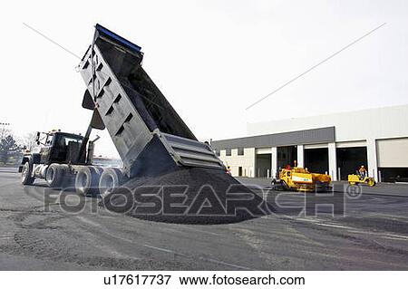 Dump truck dumping a pile of hot asphalt; Canada, Ontario, Hamilton (Composting Facility) View Large Photo Image Stock Photo - Dump truck dumping a pile of hot asphalt; Canada, Ontario, Hamilton (Composting Facility). Fotosearch