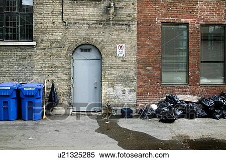 Stock Photography - Garbage and recycling in a back alley, Toronto, Ontario, Canada. Fotosearch