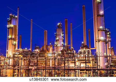 Stock Image - Lights on Oil Refinery at night; Canada, Alberta. Fotosearch