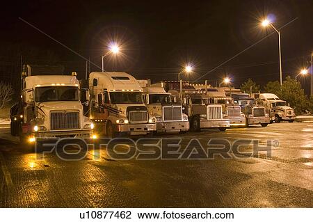 Stock Image - Parking lot for transport trucks at night; Canada, Ontario. Fotosearch