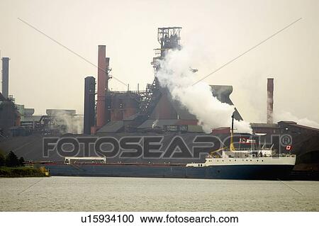 Stock Image - Ship at a steel manufacturing plant, Hamilton, Ontario.. Fotosearch