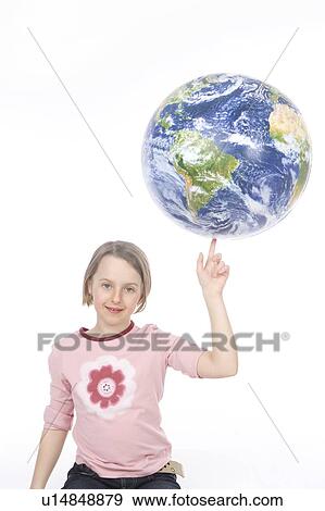 Stock Photo - 9 year old girl balances the globe on her finger. Fotosearch