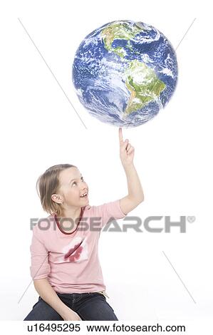 Stock Photography - 9 year old girl balances the globe on her finger. Fotosearch