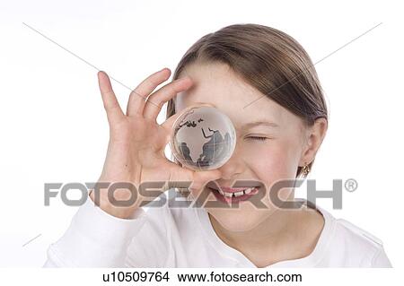 9 year old girl with the glass globe in front of her face View Large Photo Image Picture - 9 year old girl with the glass globe in front of her face. Fotosearch