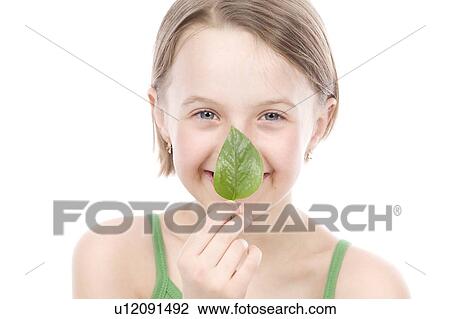 9 year old girl with the green leaf in front of mouth View Large Photo Image Stock Image - 9 year old girl with the green leaf in front of mouth. Fotosearch