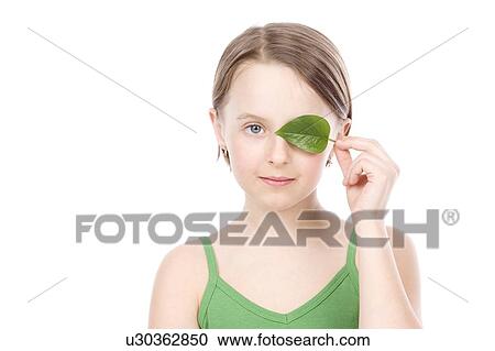 9 year old girl with the green leaf in front of her face View Large Photo Image Stock Image - 9 year old girl with the green leaf in front of her face. Fotosearch