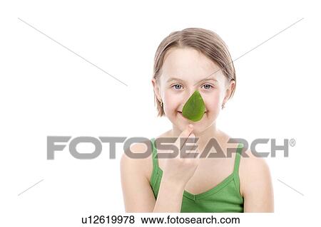 9 year old girl with the green leaf in front of mouth View Large Photo Image Stock Photo - 9 year old girl with the green leaf in front of mouth. Fotosearch
