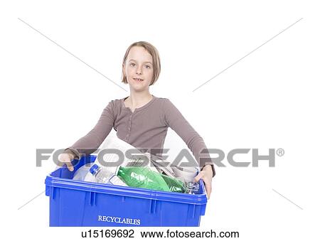 Stock Image - 9 years old girl with the recycling box. Fotosearch