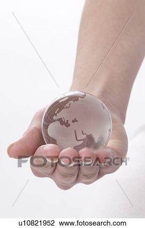 a hand with a globe View Large Photo Image Stock Image - a hand with a globe. Fotosearch