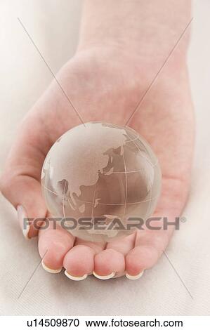 Stock Image - a hand with a globe. Fotosearch