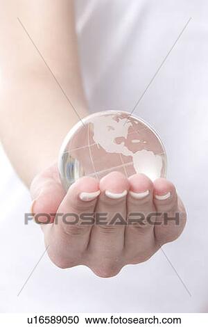 a hand with a globe View Large Photo Image Stock Image - a hand with a globe. Fotosearch