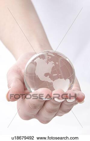 Stock Image - a hand with a globe. Fotosearch