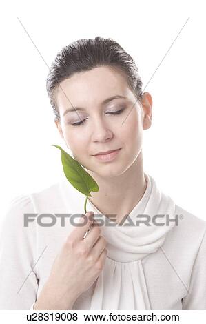 Stock Photo - face of a young woman with a leaf. Fotosearch