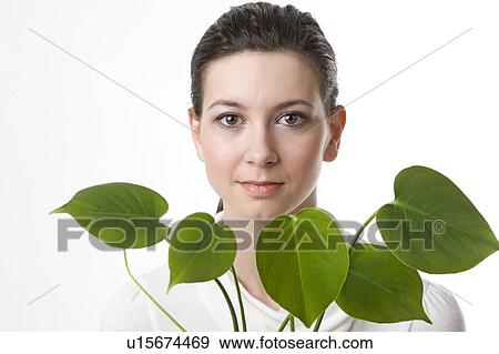 face of a young woman with leaves View Large Photo Image Stock Photo - face of a young woman with leaves. Fotosearch