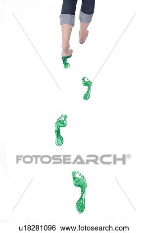 Stock Photograph - Feet walking leaving a set of green footprints. Fotosearch