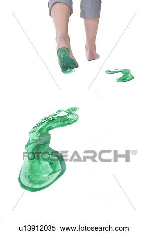 Stock Photography - Feet walking leaving a set of green footprints. Fotosearch