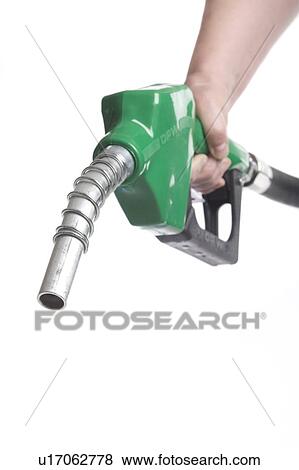 Stock Photo - Hand holds gas nozzle. Fotosearch