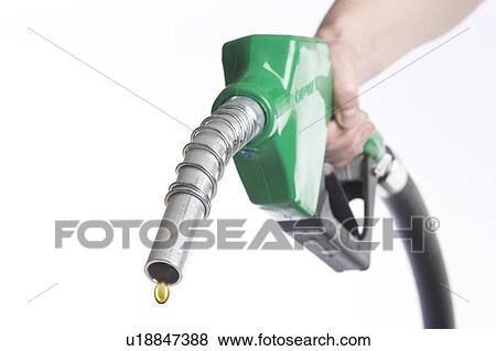 Hand holds nozzle with drop of gasoline coming out View Large Photo Image Stock Photo - Hand holds nozzle with drop of gasoline coming out. Fotosearch