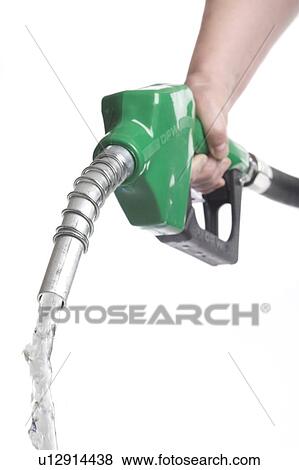 Hand holds nozzle with drop of water coming out View Large Photo Image Stock Photo - Hand holds nozzle with drop of water coming out. Fotosearch