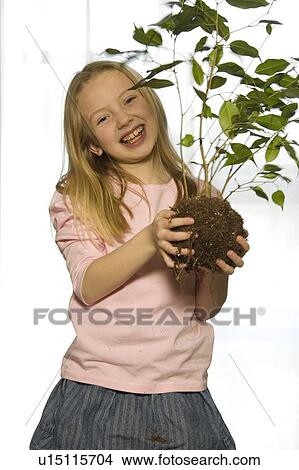 Young girl with tree sapling View Large Photo Image Picture - Young girl with tree sapling. Fotosearch