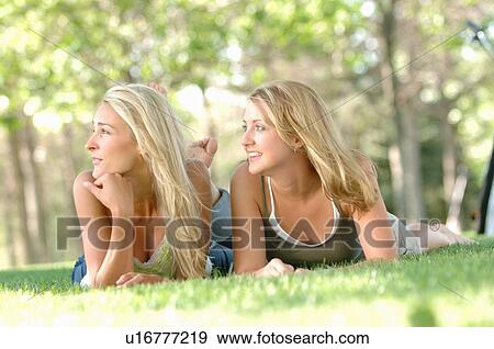 Stock Photo - 2 young blonde females in park, Regina, Saskatchewan. Fotosearch