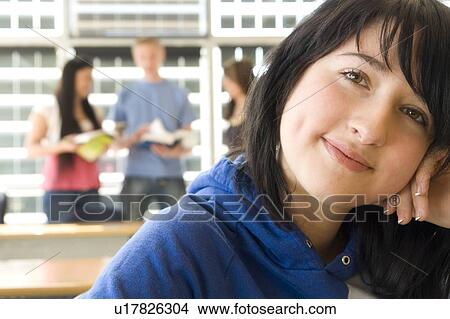 Picture - Female student foreground, group of students in background, in fron of solar panelled windows, Winnipeg, Canada.. Fotosearch
