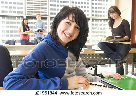 Female student foreground, group of students in background, in fron of solar panelled windows, Winnipeg, Canada. View Large Photo Image Picture - Female student foreground, group of students in background, in fron of solar panelled windows, Winnipeg, Canada.. Fotosearch