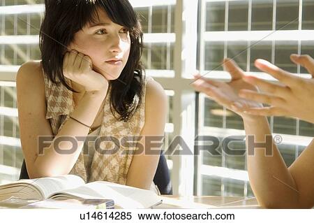 Female student listens to another student, in front of solar panelled windows, Winnipeg, Canada View Large Photo Image Stock Photography - Female student listens to another student, in front of solar panelled windows, Winnipeg, Canada. Fotosearch